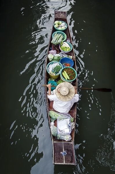 A vendor paddles their boat, Damnoen Saduak Floating Market, Thailand, Southeast Asia, Asia