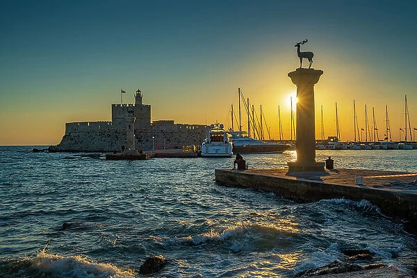 View of bronze stag and doe statues and Saint Nicholas Fortress at sunrise, UNESCO World Heritage Site, City of Rhodes, Rhodes, Dodecanese Islands, Greek Islands, Greece, Europe