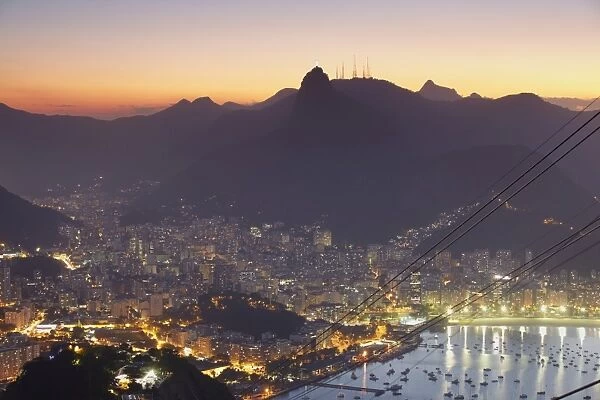 View of Christ the Redeemer statue and Botafogo Bay at sunset from Sugar Loaf Mountain, Rio de Janeiro, Brazil, South America