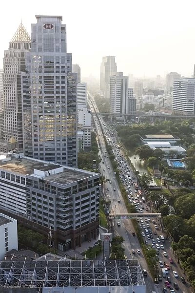 View of high rise buildings and traffic congestion on Rama IV in hazy evening light, from the roof of Hotel Sofitel So, Sathorn Road, Bangkok, Thailand, Southeast Asia, Asia