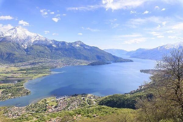 View over Lake Como and villages framed by snowy peaks, Montemezzo, Alpe Zocca, Lombardy