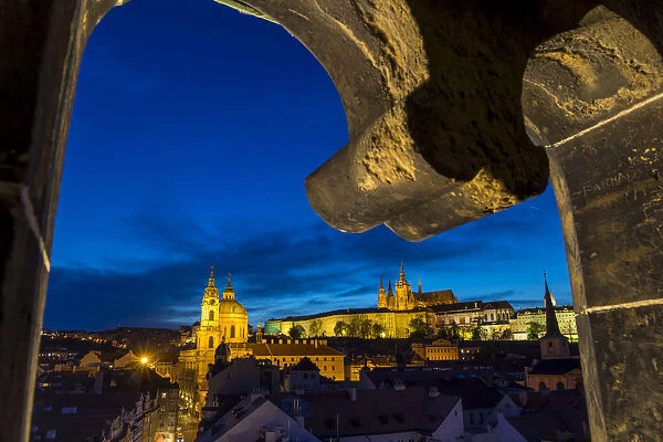 View from the Lesser Town Bridge Tower to Prague Castle and St. Nicholas Church at dusk