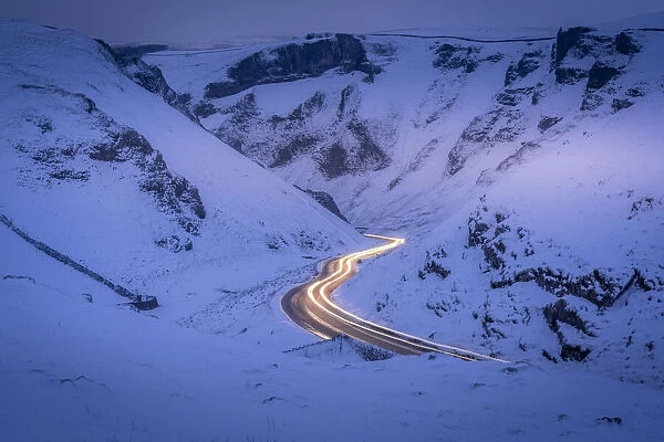 View of trail lights on snow covered Winnats Pass near Castleton, Derbyshire, England, United Kingdom, Europe