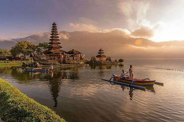 View of young couple on Cadik canoe at Ulun Danu Beratan temple on Lake Bratan at sunrise, Bali, Indonesia, South East Asia, Asia