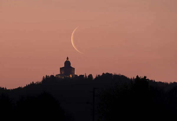 Waning crescent moon at sunrise above San Luca Sanctuary, Bologna, Emilia Romagna, Italy, Europe