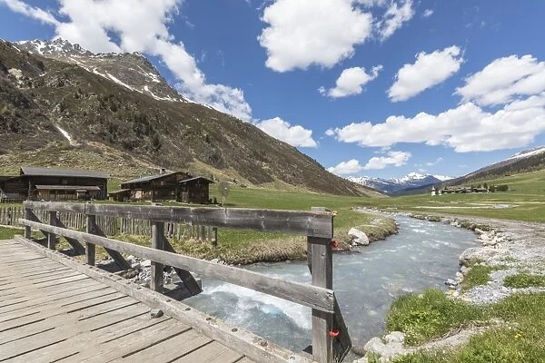 Wood bridge on the alpine river surrounding the village of Davos, Sertig Valley