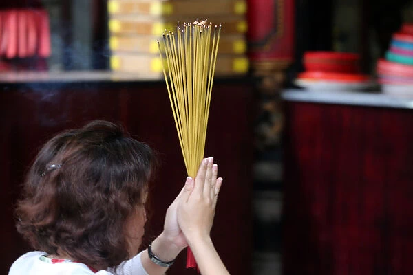Worshipper burning incense sticks, Taoist temple, Phuoc An Hoi Quan Pagoda