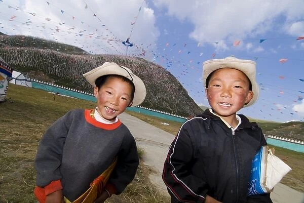 Two young boys and thousands of prayer flags, Tagong Grasslands, Sichuan, China, Asia