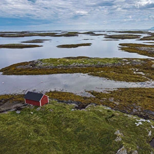 Aerial of a red boat shed on the rugged coastline of the UNESCO World Heritage Site
