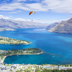 Aerial view of Queenstown, paraglider, Lake Wakatipu and The Remarkables mountains