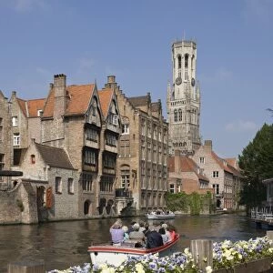 Canal view with a tour launch, Flemish gables and the Belfry tower, Brugge, UNESCO World Heritage Site, Belgium, Europe