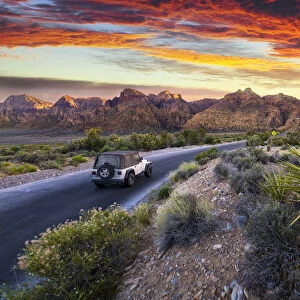 Car driving through The Red Rock Canyon National Recreation Area at sunset, Las Vegas