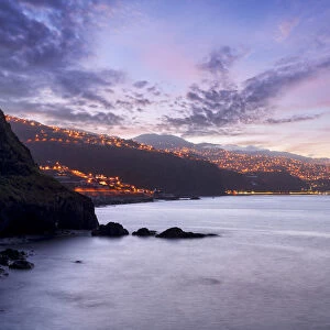 Dusk over the illuminated coastal village of Ponta do Sol, Madeira island, Portugal