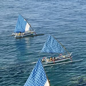 Fishing boats with blue check sails off Cape Jambela
