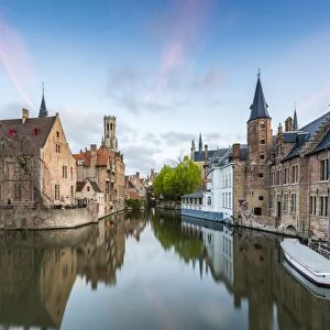 House reflections and boats on Dijver canal at dawn, Bruges, West Flanders province