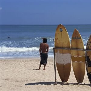 A line of surfboards waiting for hire at Kuta beach