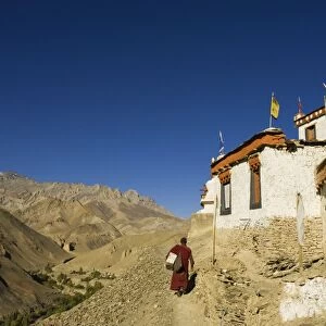 Monk walking past Lamayuru gompa (monastery)