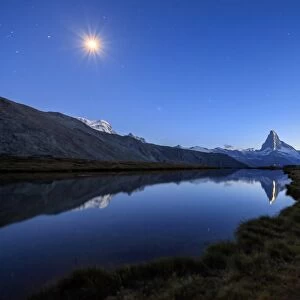 Full moon and Matterhorn illuminated for the 150th anniversary of the first ascent