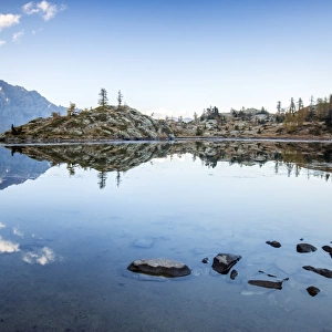 Mountain peaks reflected in Lac Blanc, Champdepraz, Natural Park of Mont Avic, Aosta Valley