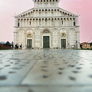 Romanesque facade of Pisa Cathedral (Duomo) under romantic sky at sunrise