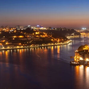 Skyline of the historic city of Porto at night with the bridge Ponte de Arrabida in the background, Oporto, Portugal, Europe