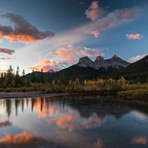 Sunrise in autumn at Three Sisters Peaks near Banff National Park, Canmore, Alberta