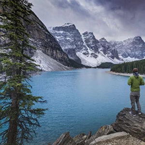 Tourist watching the scenery of the Moraine Lake, Banff National Park, UNESCO World Heritage Site