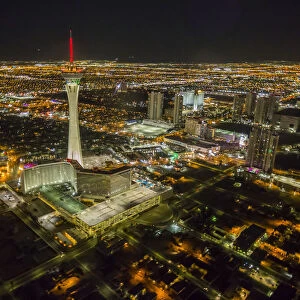 View of Las Vegas and Stratosphere Tower from helicopter at night, Las Vegas, Nevada