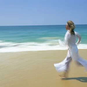 Woman running along beach