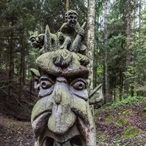 Wood carvings from traditional folklore at The Hill of Witches on the Dano River at the northern tip of the Curonian Spit, Klaipedia, Lithuania, Europe