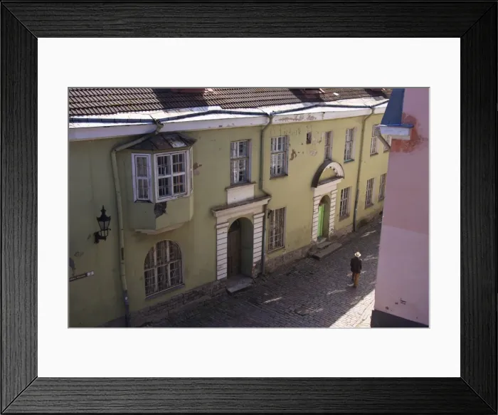 Framed Print : Man with hat in old street with pink and yellow coloured buildings, Tallinn, Estonia, Europe Framed Print : Man with hat in old street with pink and yellow coloured buildings, Tallinn, Estonia, Europe