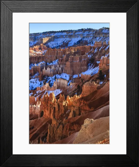 Framed Print : Hoodoos and snowy rim cliffs lit by strong late afternoon sun in winter, near Sunrise Point, Bryce Canyon National Park, Utah, United States of America, North America