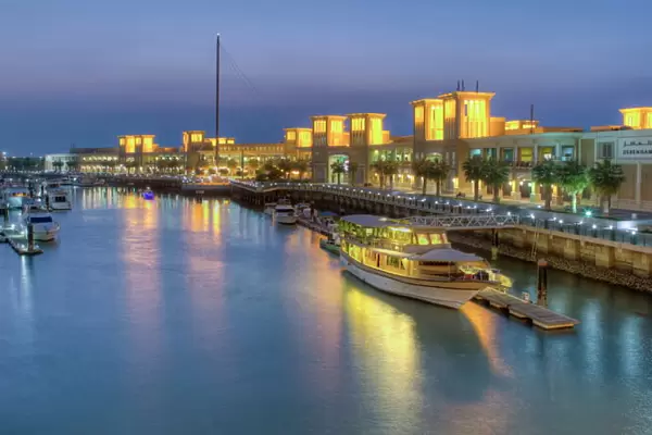 Souk Shark Mall and Kuwait harbour, illuminated at dusk, Kuwait City, Kuwait, Middle East