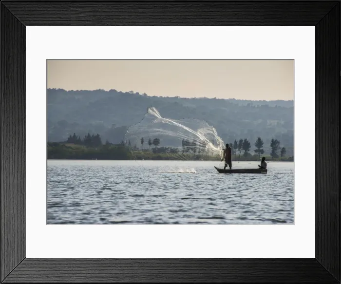 Framed Print : Local fisherman in a dug-out canoe in Jinja, Uganda, East Africa, Africa Framed Print : Local fisherman in a dug-out canoe in Jinja, Uganda, East Africa, Africa