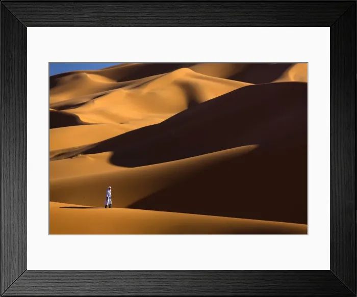 Framed Print : Berber man walking among the orange sand dunes of the Erg Chebbi sand sea, Sahara Desert near Merzouga, Morocco, North Africa, Africa Framed Print : Berber man walking among the orange sand dunes of the Erg Chebbi sand sea, Sahara Desert near Merzouga, Morocco, North Africa, Africa