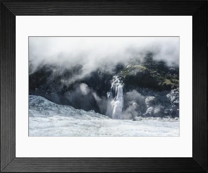 Framed Print : Aerial of a waterfall flowing into the icefield of Fox Glacier, Westland Tai Poutini National Park, South Island, New Zealand, Pacific Framed Print : Aerial of a waterfall flowing into the icefield of Fox Glacier, Westland Tai Poutini National Park, South Island, New Zealand, Pacific