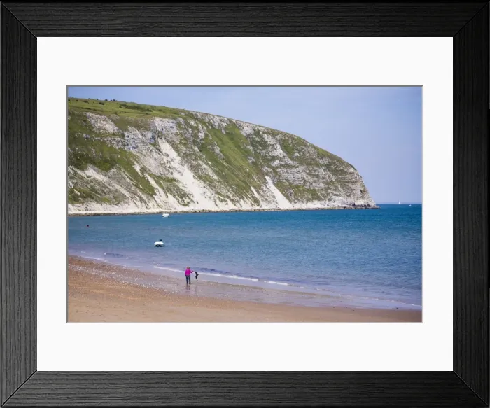 Framed Print : Swanage Beach, woman walking her dog under white cliffs, Dorset, Jurassic Coast, England, United Kingdom, Europe Framed Print : Swanage Beach, woman walking her dog under white cliffs, Dorset, Jurassic Coast, England, United Kingdom, Europe