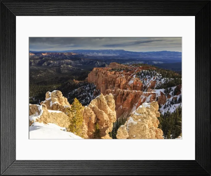 Framed Print : Wintry cliffs and hoodoos strongly lit by morning sun with cloudy backdrop, Rainbow Point, Bryce Canyon National Park, Utah, United States of America, North America Framed Print : Wintry cliffs and hoodoos strongly lit by morning sun with cloudy backdrop, Rainbow Point, Bryce Canyon National Park, Utah, United States of America, North America