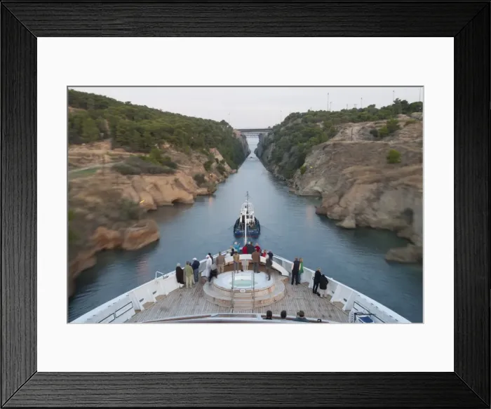 Framed Print : Tourists on the bow of a small cruise ship being pulled by a tug, early morning transit of Corinth Canal, Greece, Europe Framed Print : Tourists on the bow of a small cruise ship being pulled by a tug, early morning transit of Corinth Canal, Greece, Europe