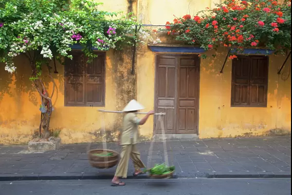 Woman carrying vegetables in street, Hoi An, UNESCO World Heritage Site, Quang Nam, Vietnam, Indochina, Southeast Asia, Asia