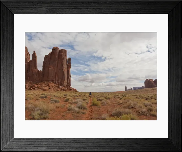 Framed Print : Navajo person rides a horse between rock formations, Monument Valley Navajo Tribal Park, Utah Arizona, United States of America Framed Print : Navajo person rides a horse between rock formations, Monument Valley Navajo Tribal Park, Utah Arizona, United States of America