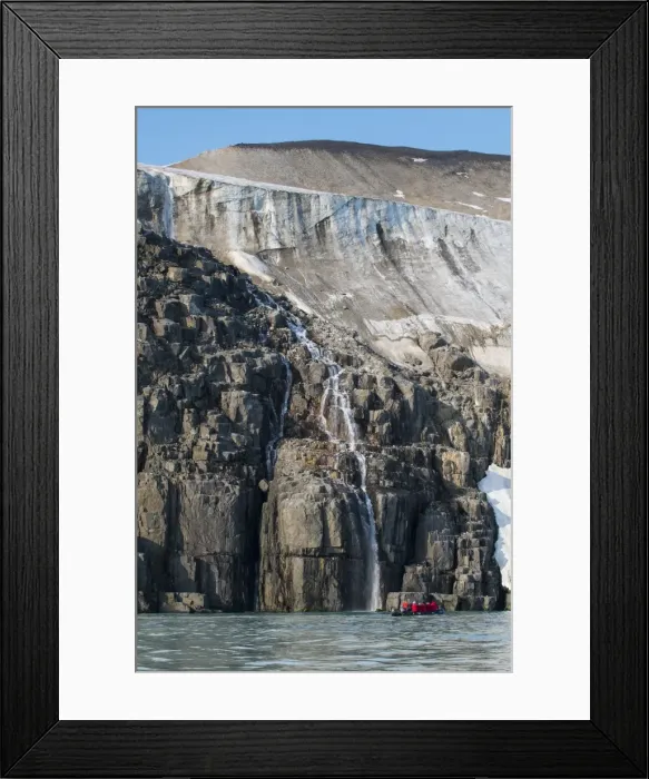 Framed Print : Tourist in a zodiac looking at Waterfall dropping in the ocean, Alkerfjellet, Svalbard, Arctic Framed Print : Tourist in a zodiac looking at Waterfall dropping in the ocean, Alkerfjellet, Svalbard, Arctic