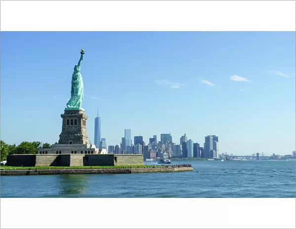 Statue of Liberty and Liberty Island with Manhattan skyline in view, New York City, New York, United States of America, North America