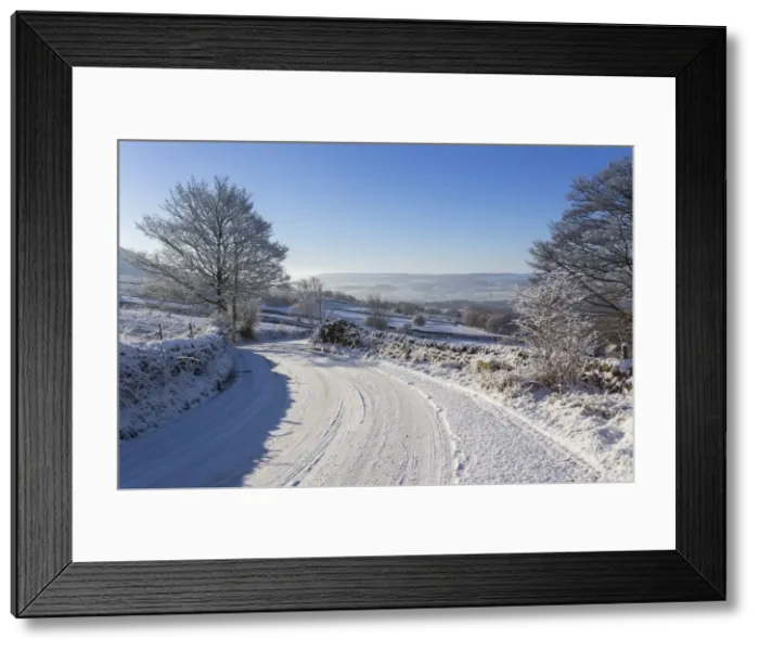 Framed Print : Snowy, bendy country lane with stone walls and trees, Curbar Edge, Peak District National Park, Derbyshire, England, United Kingdom, Europe Framed Print : Snowy, bendy country lane with stone walls and trees, Curbar Edge, Peak District National Park, Derbyshire, England, United Kingdom, Europe