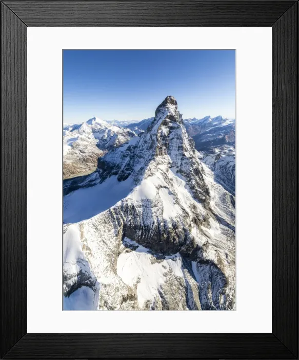 Framed Print : The unique shape of the Matterhorn sorrounded by its mountain range covered in snow, Swiss Canton of Valais, Swiss Alps, Switzerland, Europe Framed Print : The unique shape of the Matterhorn sorrounded by its mountain range covered in snow, Swiss Canton of Valais, Swiss Alps, Switzerland, Europe