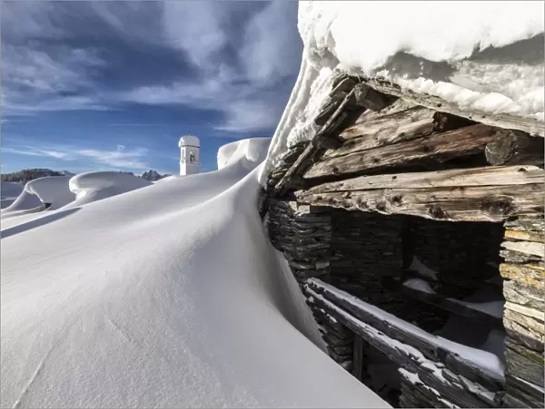 A mountain hut emerging from thick snow after a heavy snowfall in the Alpe Scima, Valchiavenna, Lombardy, Italy, Europe
