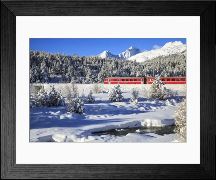 Framed Print : The Bernina Express in a snow-capped Engadine, Switzerland, Europe Framed Print : The Bernina Express in a snow-capped Engadine, Switzerland, Europe