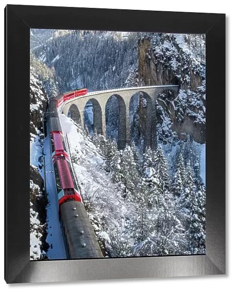 The red train of the Albula-Bernina Express Railway, UNESCO World Heritage on the famous Landwasser Viaduct, Switzerland, Europe