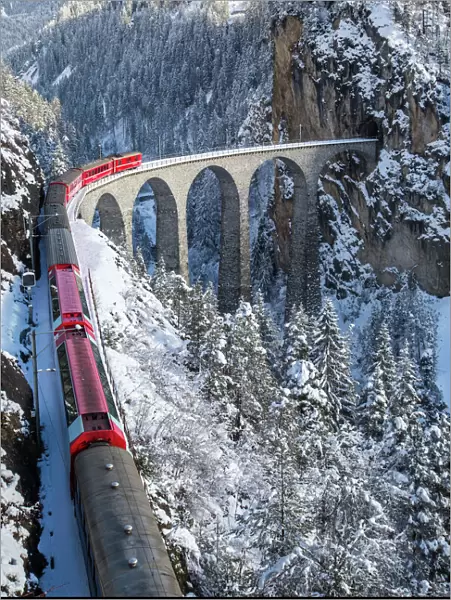The red train of the Albula-Bernina Express Railway, UNESCO World Heritage on the famous Landwasser Viaduct, Switzerland, Europe