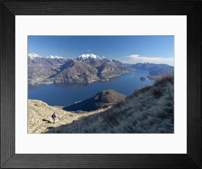 Framed Print : A tourist contemplating the landscape of Lake Como from a path in the High Route of Monti Lariani, with the village of Bellagio, Lombardy, Italy, Europe Framed Print : A tourist contemplating the landscape of Lake Como from a path in the High Route of Monti Lariani, with the village of Bellagio, Lombardy, Italy, Europe